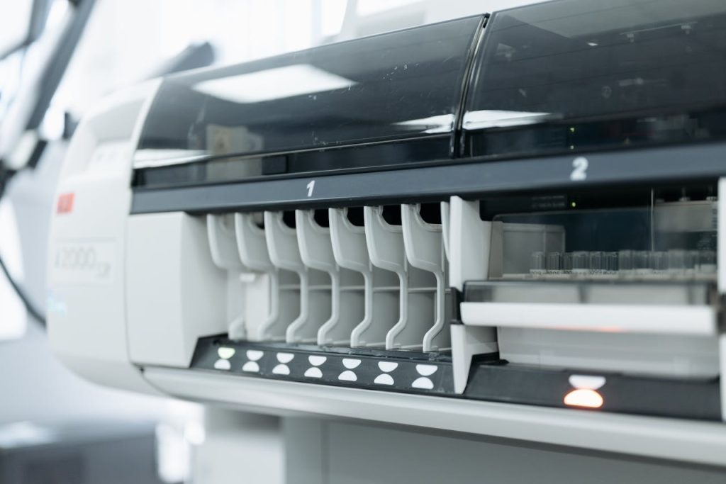 A close-up of advanced laboratory testing equipment used for medical and scientific research in a sterile environment.